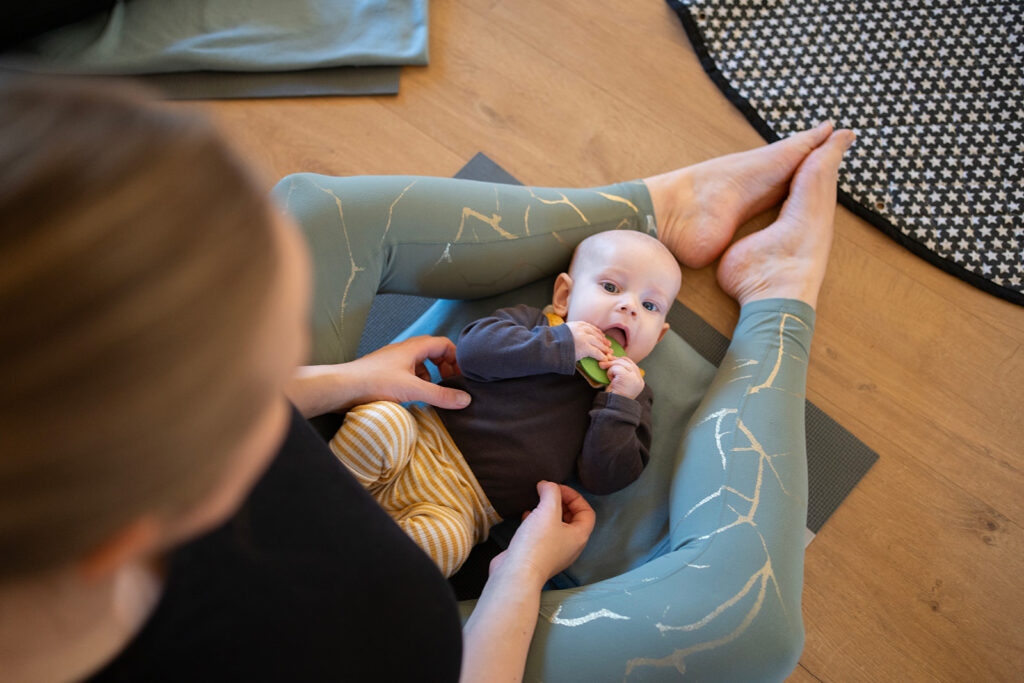 A happy baby looks up at the camera after doula support from Amy Davis in Oxfordshire