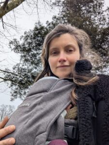 Lizzie, with newborn baby Freya in a carrier